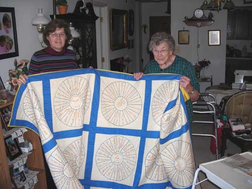 Virginia Woods and Barbara Swart hold the Barcroft Friendship Quilt